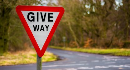 Give,Way,Uk,Road,Sign,With,Blurred,Background
